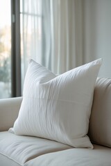 Mockup of a white pillow lying on a sofa.