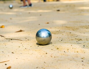 Metal ball on sandy outdoor court