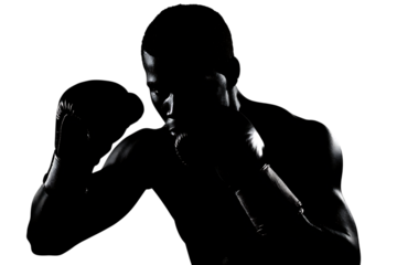 Intense boxer in dramatic black and white silhouette, ready for combat, showcasing powerful focus and athletic physique