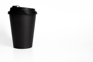 Black paper coffee cup with lid on white background. Blank template for branding, packaging design or logo mockup, minimalist style.