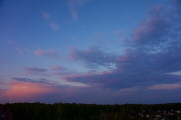 Fototapeta premium Clouds over the forest in summer