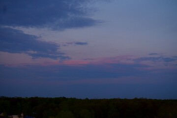 Fototapeta premium Clouds over the forest in summer