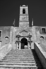 stone bell tower, gate and stairs to the historic monastery of Agia Triada on the island of Crete