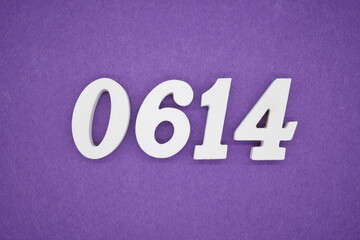 The numbers are made of white painted wood, placed on a purple paper background.