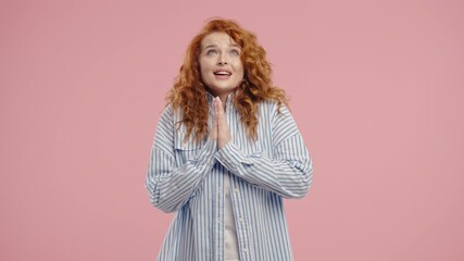 Young pretty woman praying with palms in sincere silent request. Hope, faith