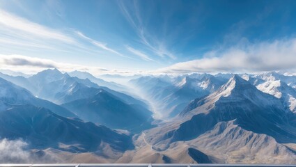 Fototapeta premium Mountains and sky from above, showcasing rugged terrain and cloud formations.