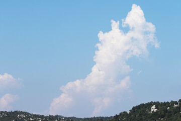 Striking cumulus cloud, likely a Cumulus Congestus, a type of puffy, vertically developing cloud...
