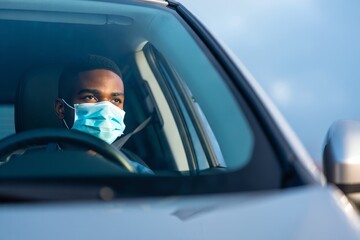 Man Driving Car Wearing Face Mask - Safety and Travel