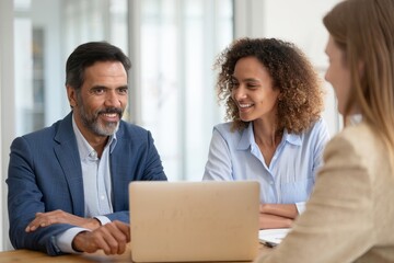 Diverse Business Team Meeting with Laptop and Smiling