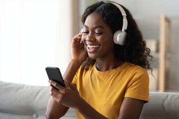 Smiling Black Woman Listening to Music with Headphones and Smartphone