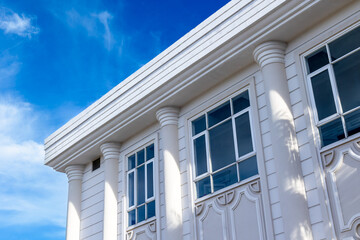Neoclassical architecture with white columns and blue sky backdrop