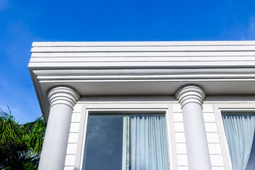 Neoclassical architecture with white columns and blue sky