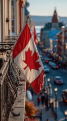 Canadian flag waves proudly over a bustling street in Quebec City during late afternoon sunlight