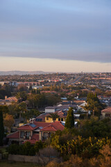 Obraz premium Aerial view of Johannesburg city centre at sunrise, South Africa. The skyline is bathed in warm morning light with urban streets, and a vibrant city atmosphere representing modern Africa.