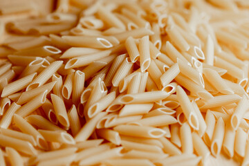 Close-up of uncooked penne pasta on wooden surface