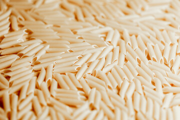 Close-up of uncooked penne pasta background