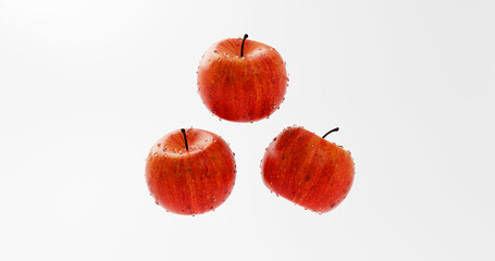 Three Floating Apples with Water Droplets on White background