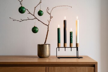 Minimalist Christmas Still Life with Branch, Ornaments, and Candle Holder
