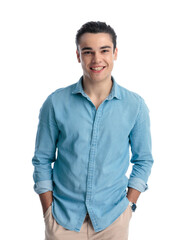 handsome casual man in blue denim shirt holding hands in pockets