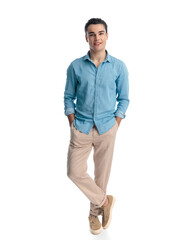 Fototapeta premium handsome young man in blue jeans shirt holding hands in pockets