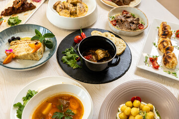 Traditional Middle Eastern dishes served on a white table in restaurant interior