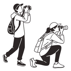 Two people with cameras and backpacks one standing and one kneeling capturing moments