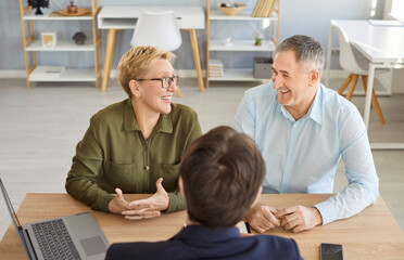 Happy senior couple visiting realtor, agent, discussing insurance agreement, real estate contract...