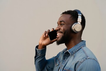 Smiling Man Talking on Phone While Wearing Headphones