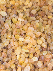 Bulk golden raisins dried and stacked together. Natural food background.