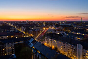 Aerial View of Cityscape at Sunset with Light Trails