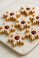 Homemade star-shaped jam cookies with powdered sugar on parchment paper