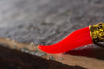 Red lucky horn on dark background