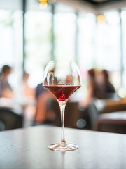 Elegant Wine Glass with Red Wine in a Modern Restaurant Setting