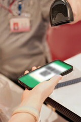 Mobile phone scanning a QR code with a barcode scanner