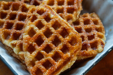 Macro close-up of freshly baked golden brown croffles with crispy texture and caramelized surface. Perfect food photography for illustrating breakfast, brunch, dessert, bakery, and homemade snack
