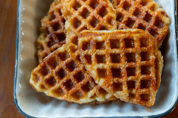 Macro close-up of freshly baked golden brown croffles with crispy texture and caramelized surface. Perfect food photography for illustrating breakfast, brunch, dessert, bakery, and homemade snack