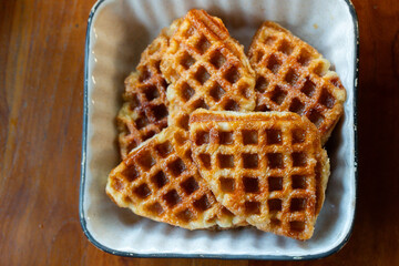 Macro close-up of freshly baked golden brown croffles with crispy texture and caramelized surface. Perfect food photography for illustrating breakfast, brunch, dessert, bakery, and homemade snack