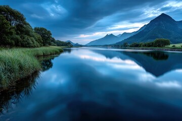 Fototapeta premium Serene Blue Lake Reflecting Mountains at Dusk