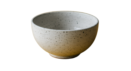 A speckled ceramic bowl awaits its fill radiating understated elegance and a promise of simple pleasures against a stark