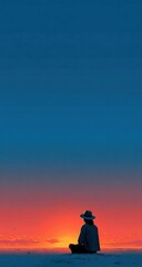 Fototapeta premium Silhouette of a person in a hat sitting during a vibrant sunset; deep blues and oranges