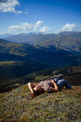 Fototapeta premium Happy woman enjoying freedom and fresh air on mountain top, relaxing in nature with scenic landscape view, travel and wellness lifestyle inspiration outdoors