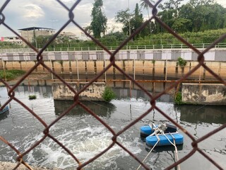 Rusty chain link fence with blurred river background
