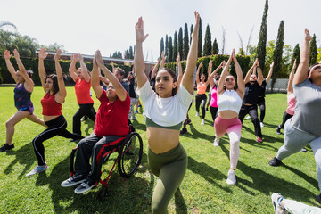 Large Group portrait of Latin sporty excited multi age people stretching to workout or training class in a public park in Mexico Latin America 