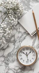 Flat lay of white flowers, notepad, pencil, and clock on marble