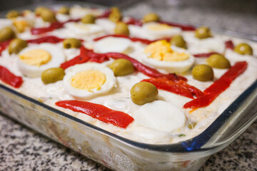 Traditional Spanish Ensaladilla Rusa with Boiled Eggs, Red Peppers and Olives