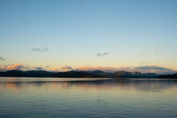 Obraz premium Sunrise Over Mountains and Ocean in Amami Oshima