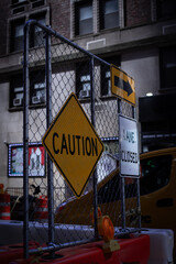 Urban Street Sign Cluster Highlighting Road Work and Caution