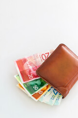 Leather wallet with  banknotes and credit cards.