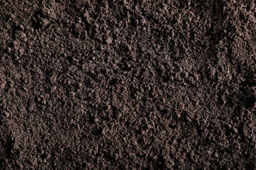 Fototapeta premium Fresh soil as background, top view. Organic matter