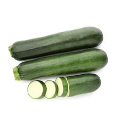 Whole and cut fresh zucchinis isolated on white, top view